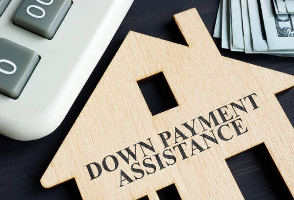Down payment assistance written on a model of home.