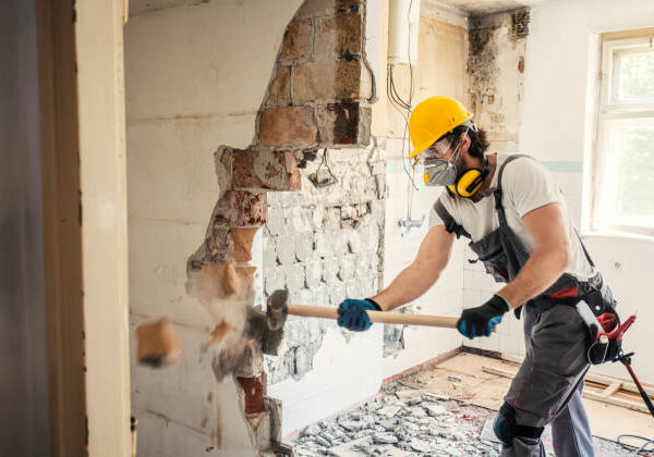 Worker using hammer, home renovation