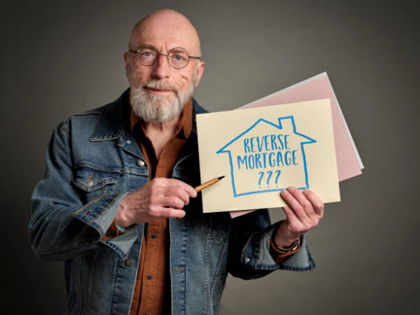 reverse mortgage question - senior man, businessman, mentor or advisor with handwritten sign, retirement financial concept